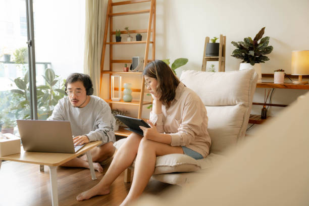 istock Young Asian couple study online together at home 1414562109