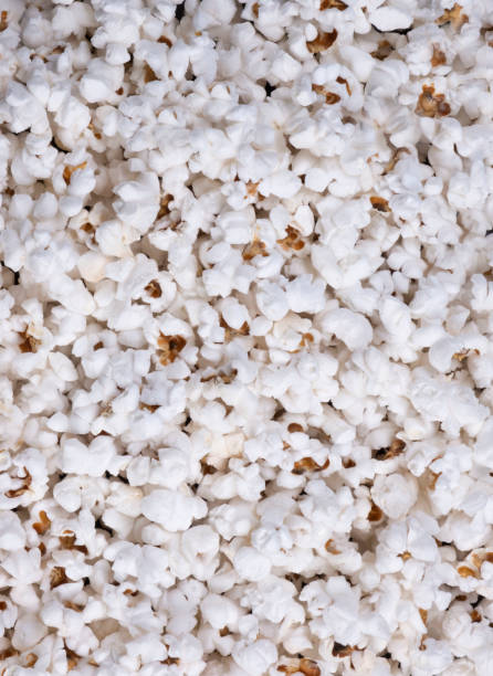 istock Vertical background of popcorn top view closeup 1414563823
