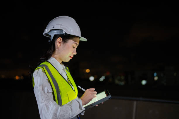 istock Asian engineers woman work late at night. 1414568286