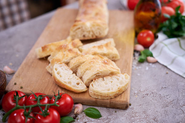 istock Sliced French bread baguette on wooden bread board 1414574541