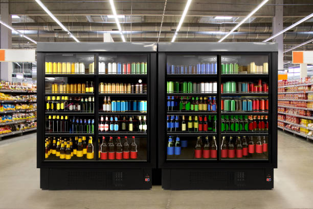 Beer in Fridge at liqor store Beer Fridge Glass door fridge Horizontal photo mockup Beer bottles and cans in freezer at supermarket. Suitable for presenting new beer bottles and packaging or label designs among many others grocery shelf cans stock pictures, royalty-free photos & images
