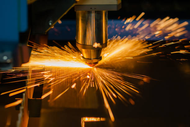 istock CNC laser cutting machine working with sheet metal with sparks 1414581745