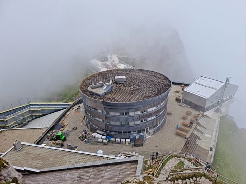 Pilatus Kulm with aerial cable car captured during a foggy day in summer season.