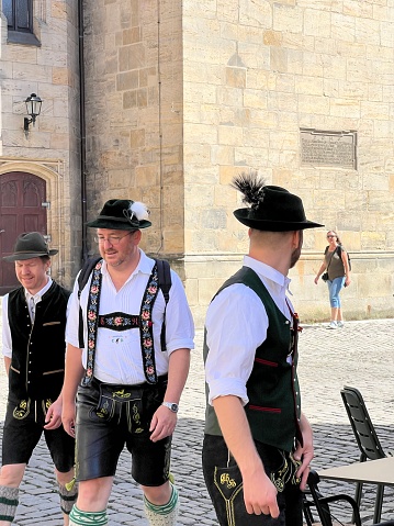 Bayreuth, Germany - August 6 - 2022: Men in traditional Bavarian clothing with lederhosen and gamsbart hats.