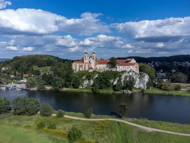 Historic monastery buildings on a high rock above the Vistula River.
