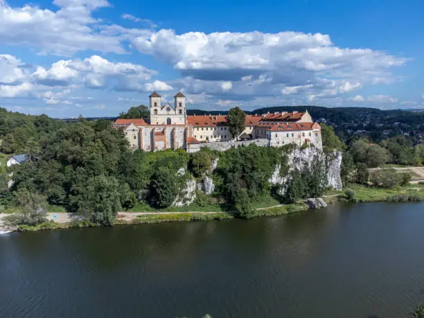 Historic monastery buildings on a high rock above the Vistula River.