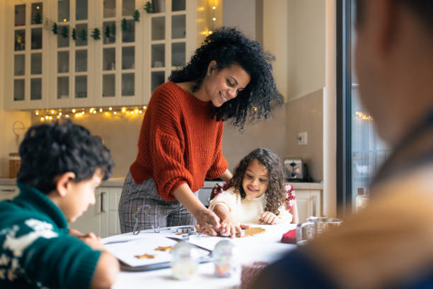 istock Mother making Christmas gingerbread cookies with kids 1414586413