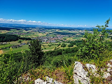 View over hills and villages in the canton of Zurich. Seen from the Lägern hills, a jurassic limestone hill between Baden and Dielsdorf. The image was captured during summer season.
