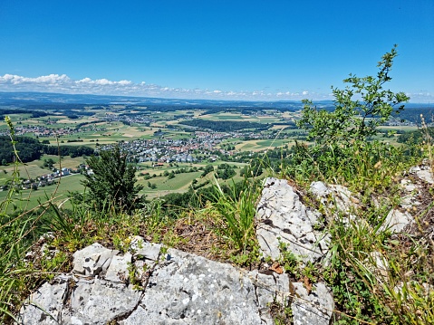 View over hills and villages in the canton of Zurich. Seen from the Lägern hills, a jurassic limestone hill between Baden and Dielsdorf. The image was captured during summer season.