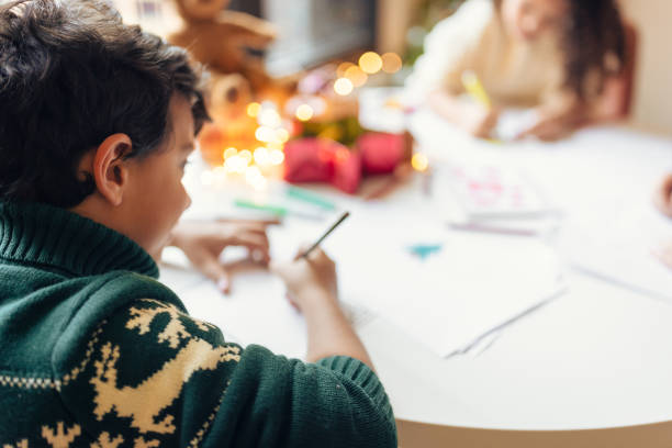 istock Kids drawing Christmas cards 1414587545