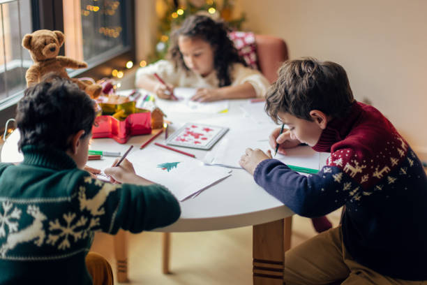 istock Kids drawing Christmas cards 1414587597
