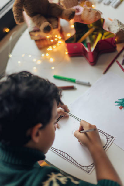 Kids drawing Christmas cards stock photo