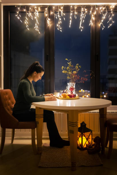 istock Woman reading book alone at Christmas 1414589749