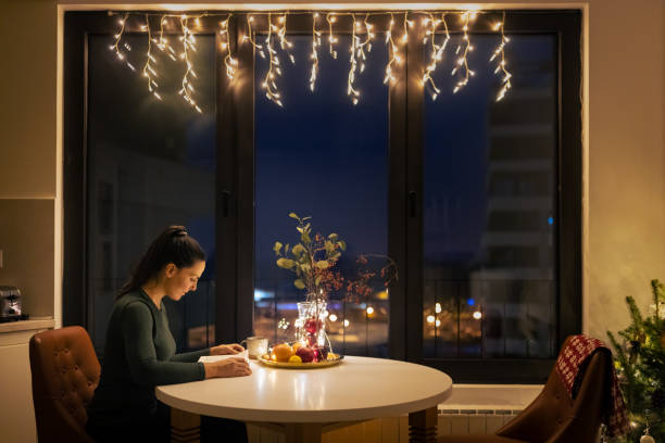 istock Woman reading book alone at Christmas 1414589759
