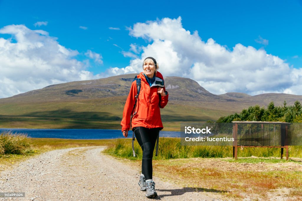 Wilderness walking in Scottish Highlands Woman hiking Loch Ericht to Culra Bothy in the Highlands of Scotland. Women Stock Photo