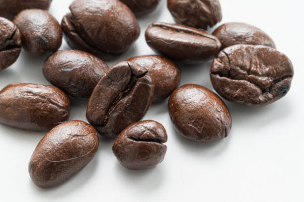 istock Coffee beans macro close-up, white background 1414592389