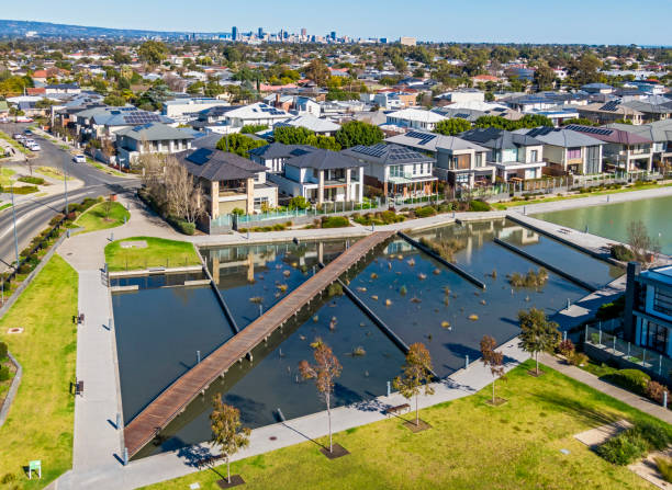 istock Aerial view looking down on modern housing development with public park and lake created from stormwater catchment and treatment infrastructure 1414595776