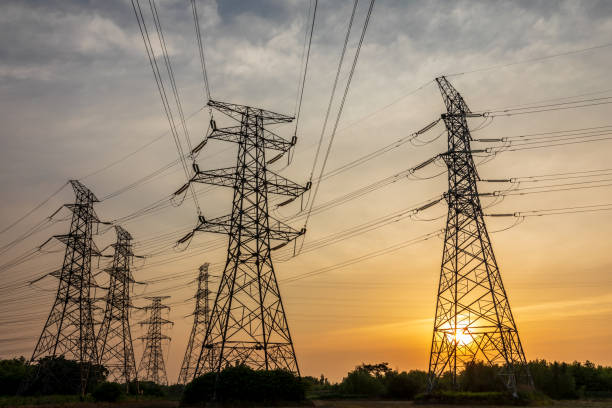 High voltage electric tower at sunset stock photo