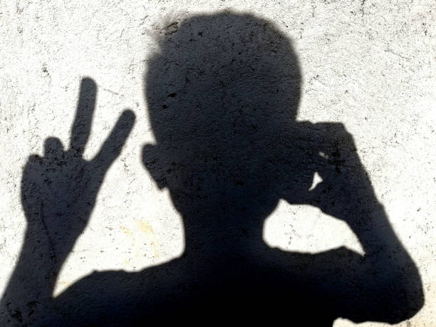 istock Silhouette of a man,showing two fingers 1414597849