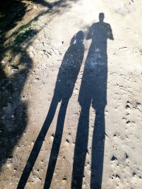 istock Silhouette of two peoples under sunny day 1414598752