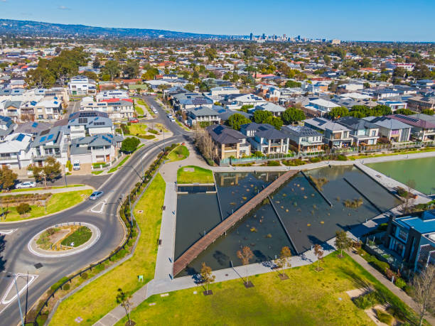 istock Aerial view looking down on modern housing development, road system, public park and lake created from stormwater catchment and treatment infrastructure 1414598967