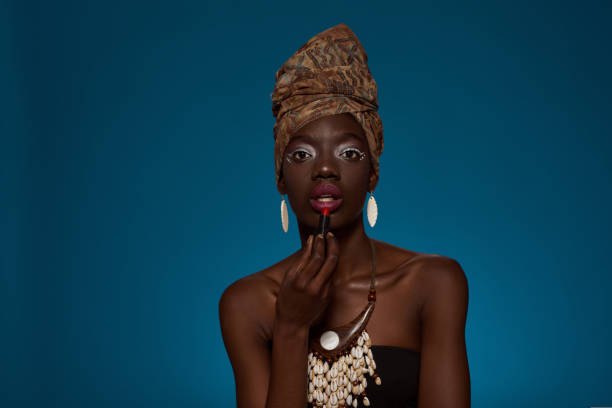 istock Girl paint lips with lipstick and look at camera 1414601578