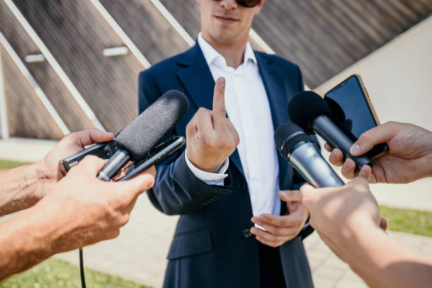 istock Politician doing obscene gesture while talking to journalists in interview 1414602598