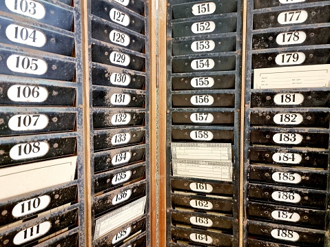 Time clock cards captured in a former textil factory. Time clock with several demonstration punch cards.