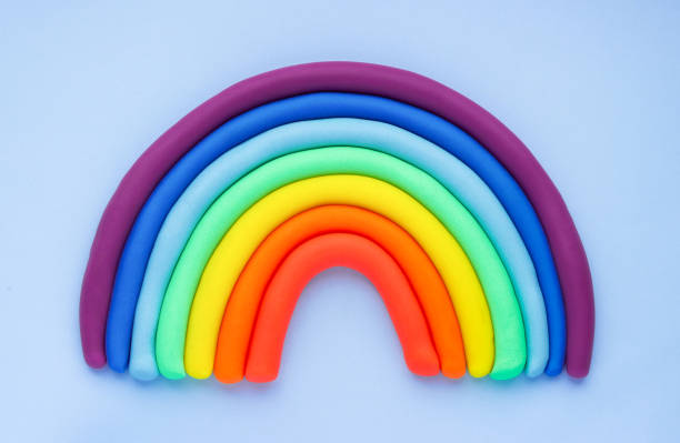 istock Colorful rainbow of plasticine on blue background. Made from plasticine. Isolate 1414604635