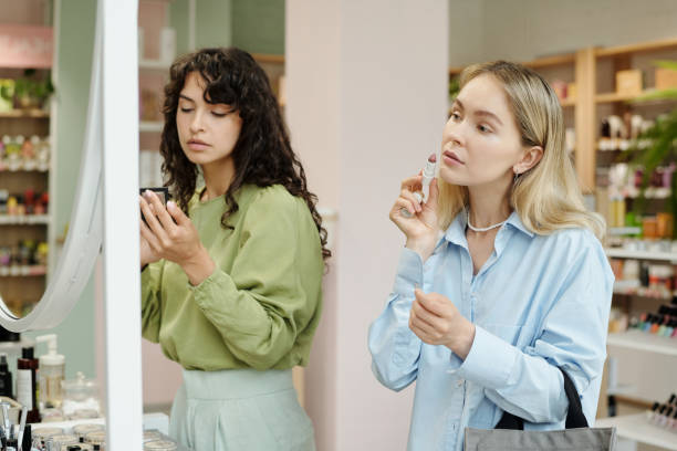 istock Young blond female consumer testing concealer stick on her face 1414606926