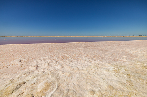 Scenic view of beautiful salt lake against clear blue sky during sunny day