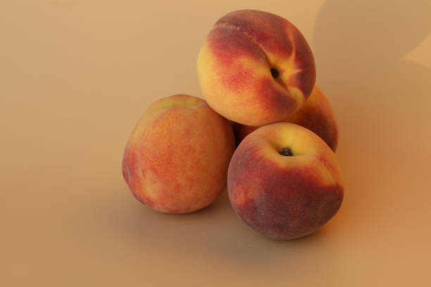 Fresh cut peach on the yellow background