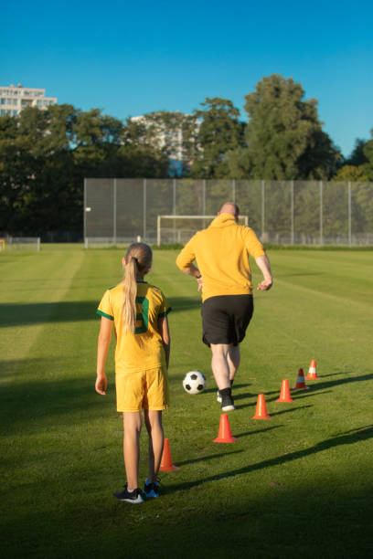 istock Soccer father and daughter working hard during a coaching session 1414608432
