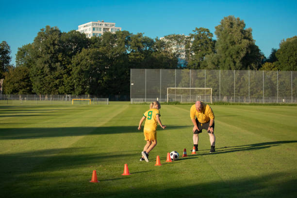 istock Soccer father and daughter working hard during a coaching session 1414608470