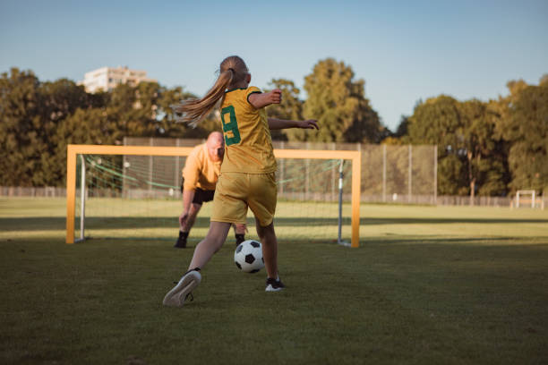 istock Soccer father and daughter working hard during a coaching session 1414609120