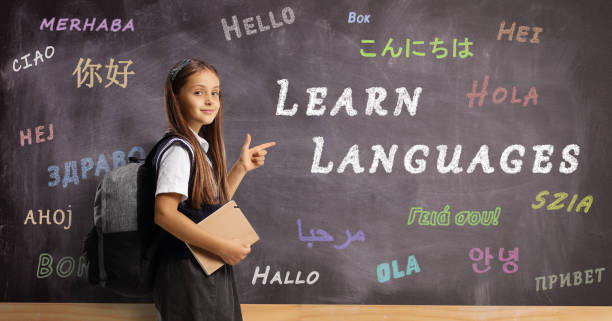 istock Schoolgirl with a backpack and book pointing at a blackboard in a foreign language school 1414609138