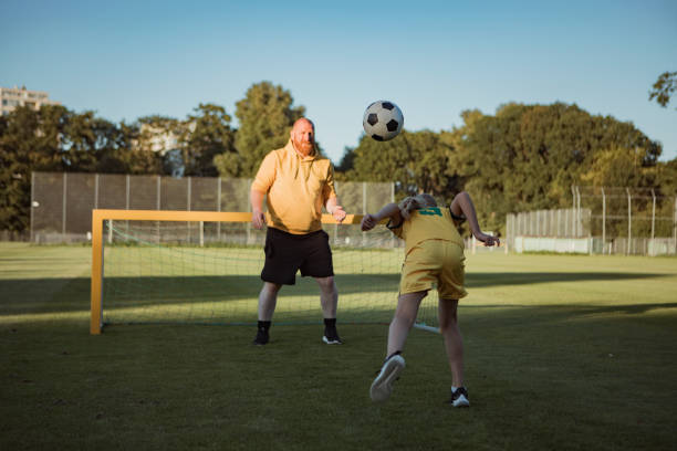 istock Soccer father and daughter working hard during a coaching session 1414609162