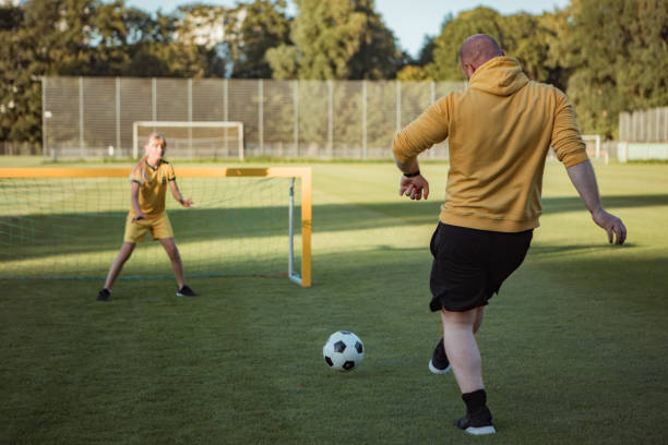 istock Soccer father and daughter working hard during a coaching session 1414609437