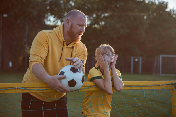 istock Soccer father and daughter resting during a coaching session 1414609619
