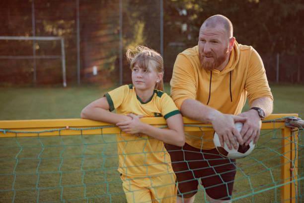 istock Soccer father and daughter resting during a coaching session 1414609736