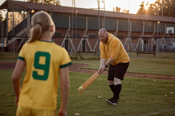 istock Cricket father and daughter working hard during a coaching session 1414610281