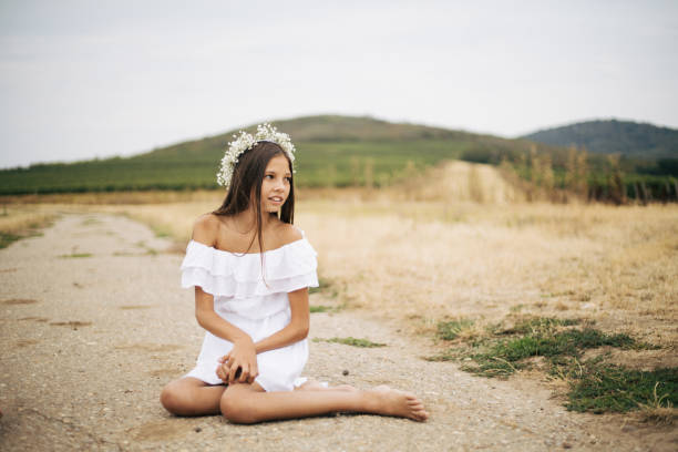 White T-shirt andmdresses, all in amazing and beautiful family atmosphere. Children with big smiles and positive energy making vineyard look as heaven on Earth. Mother is always there to make everything even better. With flowers on girls head.