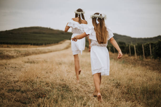 White T-shirt andmdresses, all in amazing and beautiful family atmosphere. Children with big smiles and positive energy making vineyard look as heaven on Earth. Mother is always there to make everything even better. With flowers on girls head.