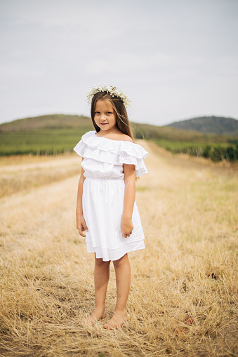 Portraits of a beautiful 4-year-old Argentine girl in a flower field- Buenos Aires - Argentina