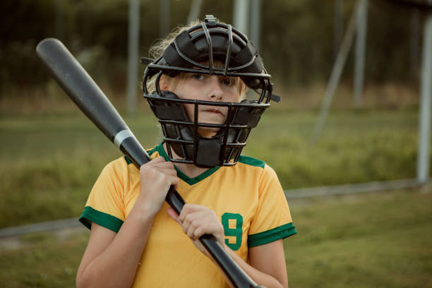istock Baseball girl on a diamond with a baseball bat 1414610868
