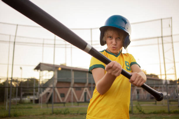 Baseball girl on a diamond with a baseball bat