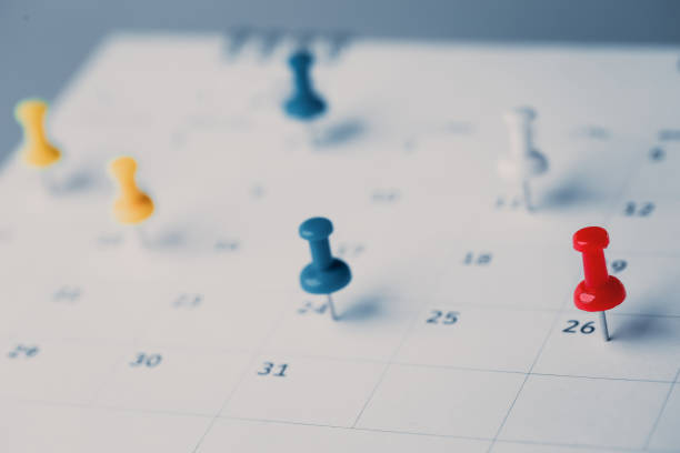 istock Embroidered red pins on a calendar event Planner calendar,clock to set timetable organize schedule,planning for business meeting or travel planning concept. 1414612691
