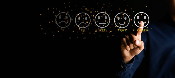 istock Customer service and Satisfaction concept ,Businessman are touching the virtual screen on the happy Smiley face icon to give satisfaction in service. 5-star rating very impressed. 1414613176