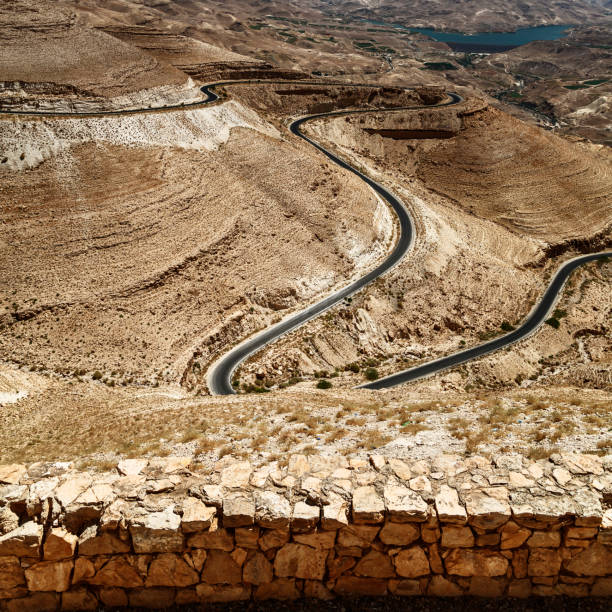 istock road with curves towards wadi rum 1414614331