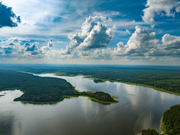 Big lake with green shores in bright sun light, aerial landscape. Recreation concept. Aerial view Big lake with green shores in bright sun light, aerial landscape. Recreation concept. Sky reflection. Ecology in Europe. Aerial view river system stock pictures, royalty-free photos & images